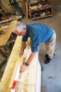 Talbot shows me a table project he's working on. It uses a series of sliding dovetail joints to allow the table to expand. Photo: Aaron Orlando/Revelstoke Mountaineer