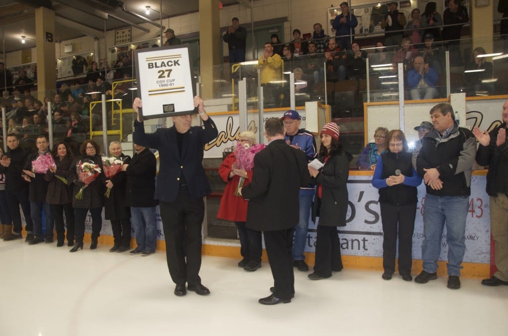 George Gertzen holds a picture memorializing Revelstoke hockey organizer Larry Black. He is joined by Revelstoke hockey establishment figures, members of the Black family and the Volpatti family. Photo: Aaron Orlando/Revelstoke Mountaineer