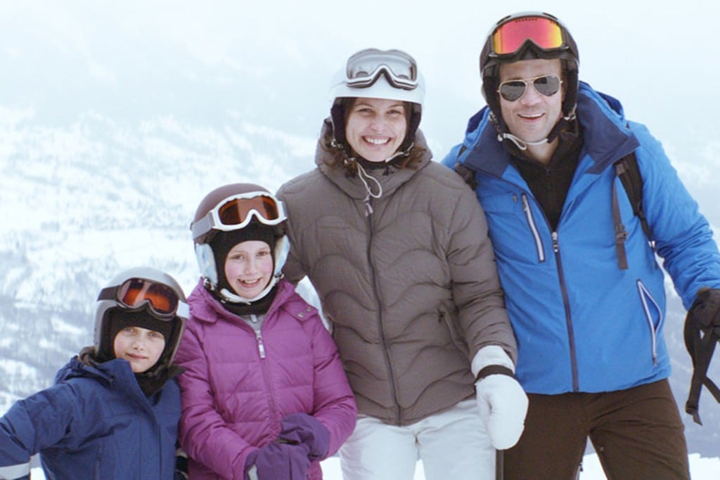 The happy family smiles for a tourist photographer on their ski holiday. Photo; Publicity shot.