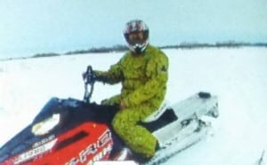 In this image circulated to media, Travis Brown is seen on the red and white Polaris RMK sled with a distinct green matching jacket and pants he is believed to be wearing when he went missing. Photo: MarckGagne