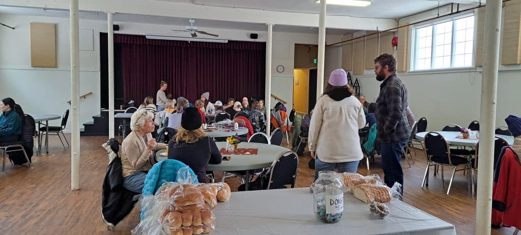 Soup and a Smile donation table loaded with breads and pastries for gusts to take.